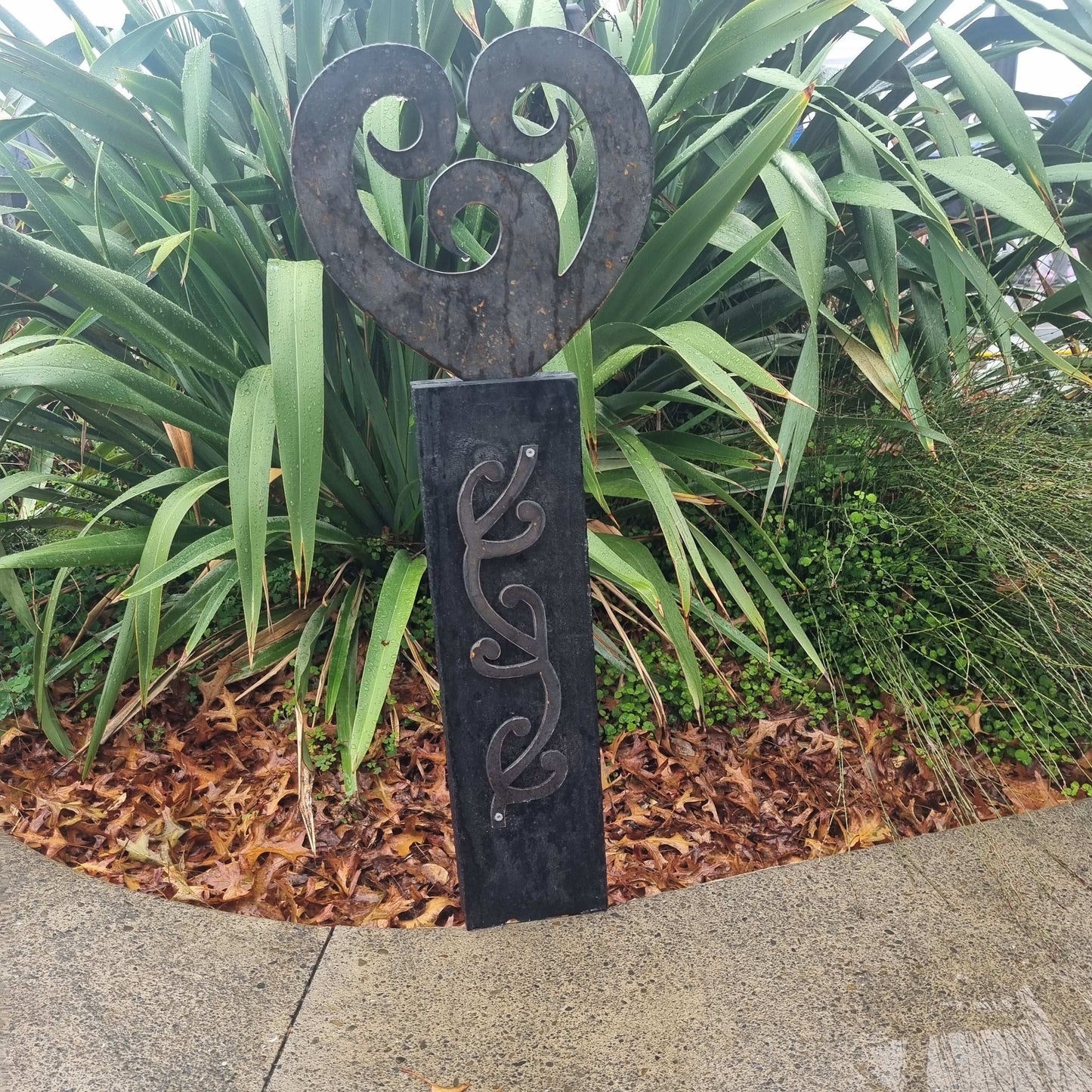 Corten koru heart on black stained Post-Garden Art