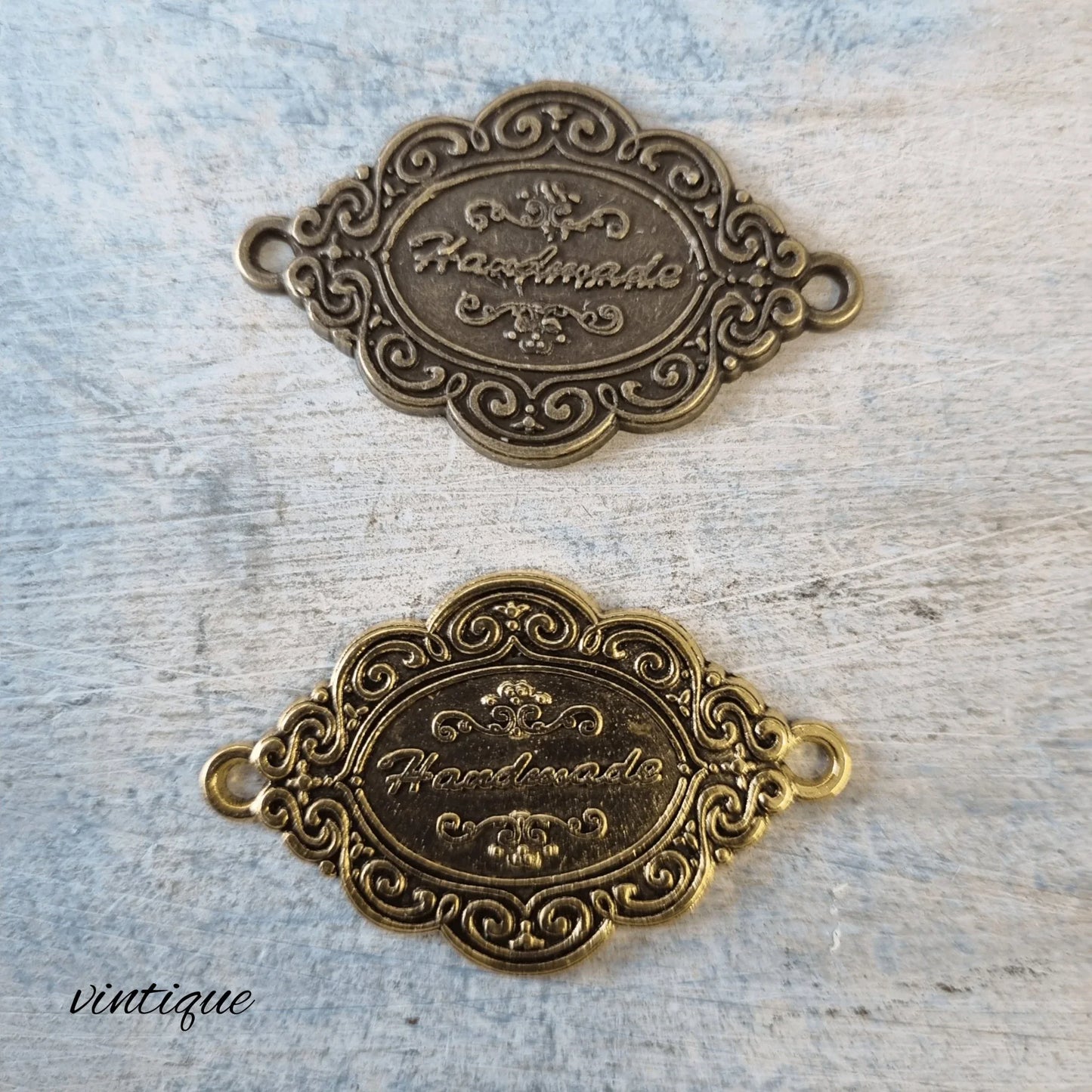 Antique metal "handmade"tag Gold 42mm x 26mm - Vintique Concepts