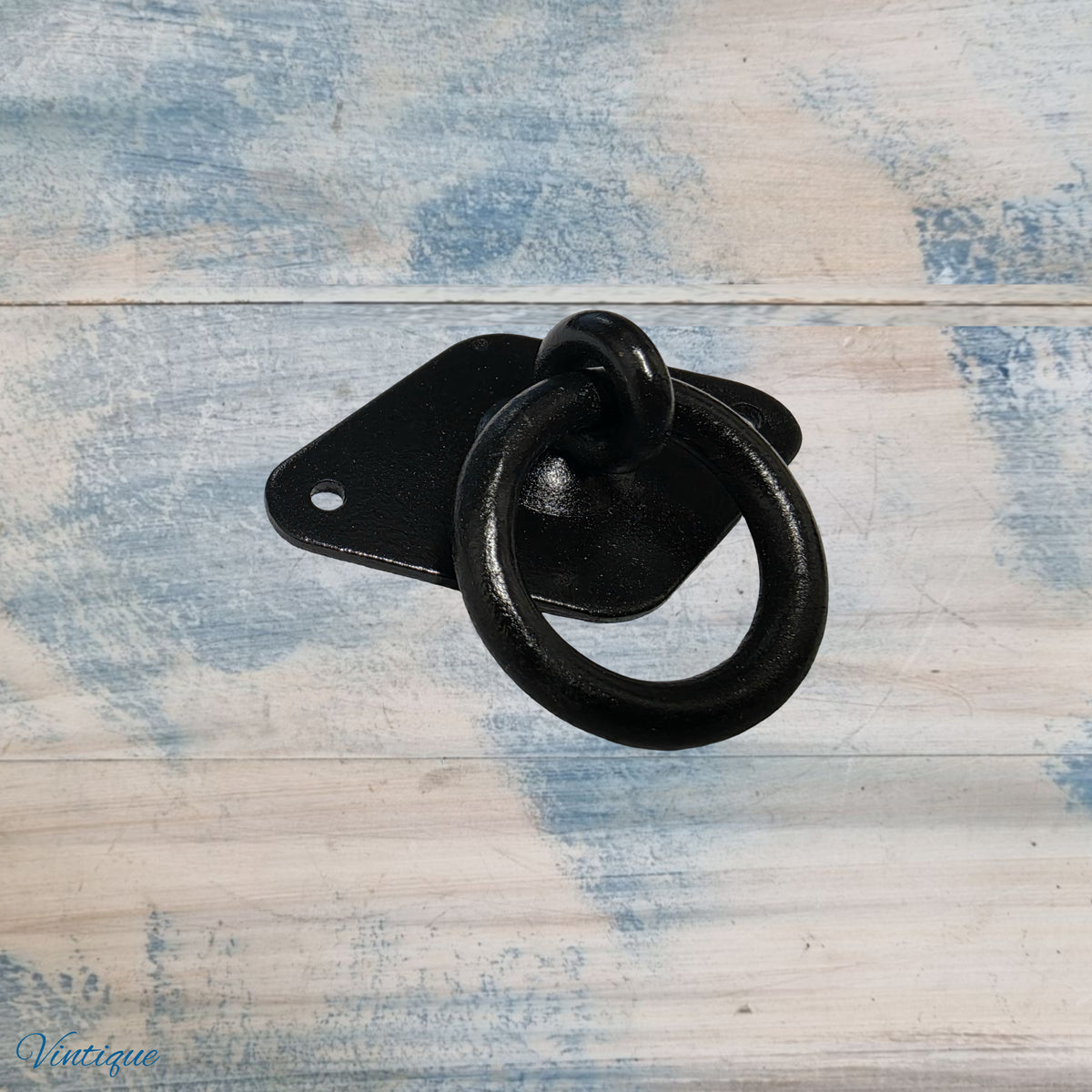 Black forged iron ring pull with a 38mm diameter, mounted on a rectangular plate, rustic design.