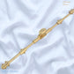 A polished brass decorative rod or finial with ornate ends and a central oval knob, .