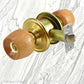 Birch door knob with a gold finish and lock mechanism, featuring a stylish rose design.