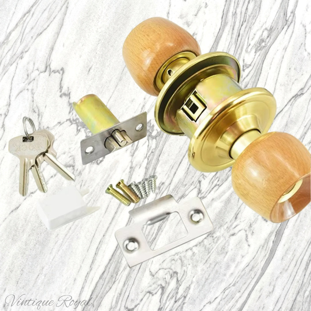 Birch door knob with a stylish rose, gold finish, includes keys, screws, and latch plate on a marble background.