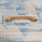 Lacquered wooden drawer knob, 117mm long, with two screw holes, displayed on a textured blue background.