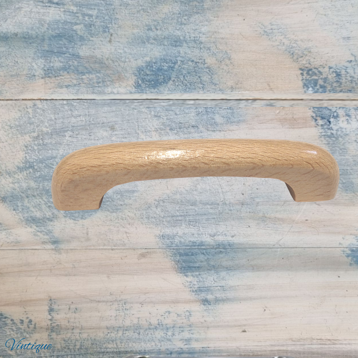 Lacquered wooden drawer knob with a smooth, rounded design, featuring a light wood finish and a glossy surface.