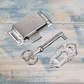Antique silver latch lock set with key and escutcheon, featuring ornate details and a shiny finish.