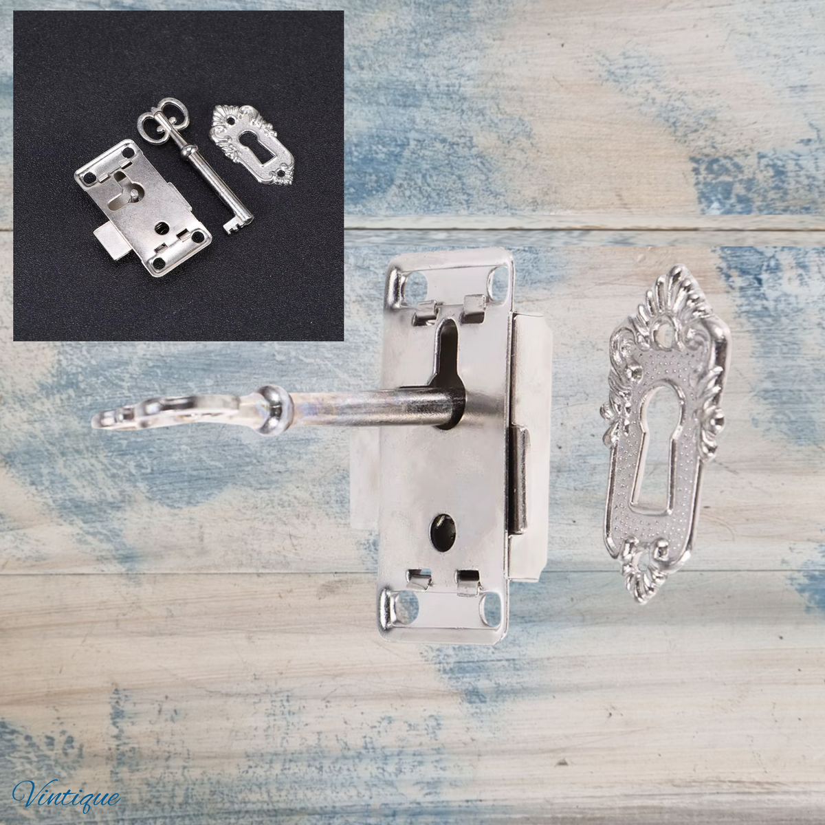 Antique silver latch lock set with key and escutcheon, featuring ornate detailing and a shiny finish.